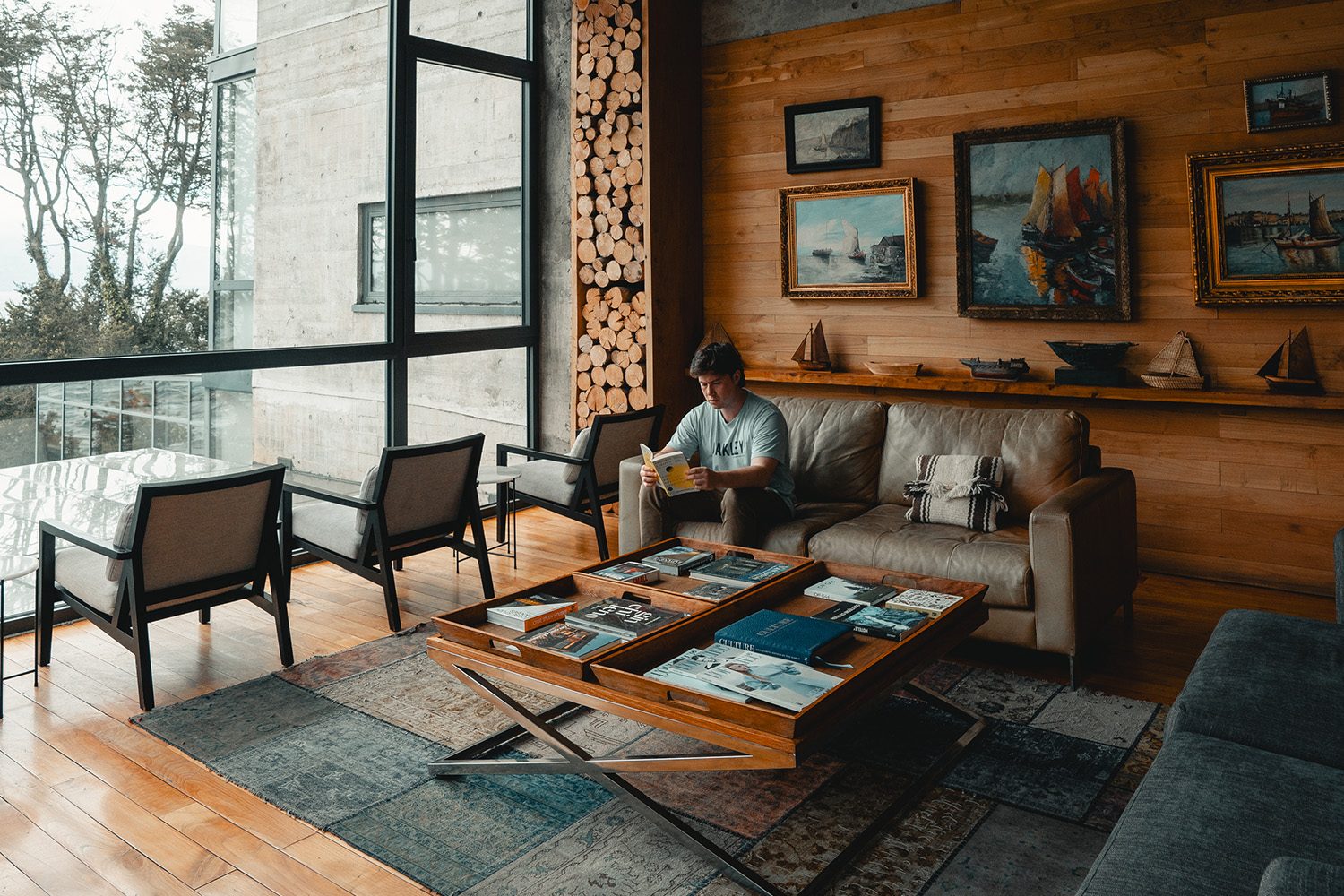 A warm wood lounge with curated maritime art at Hotel AWA